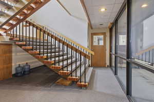 Stairs with a drop ceiling and recessed lighting