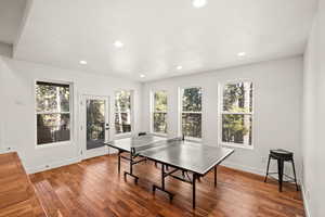 Recreation room featuring hardwood / wood-style floors, recessed lighting, and a textured ceiling