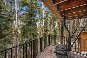 Wooden deck featuring view of scattered trees