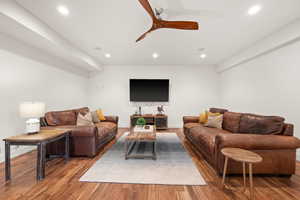 Living room with a ceiling fan, wood finished floors, and recessed lighting