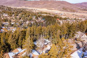 Snowy aerial view with a mountain view and a residential view
