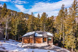 View of front of home featuring solar panels and a garage