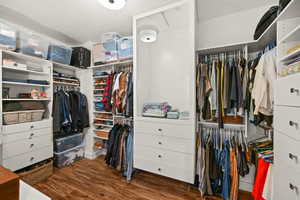 Walk in closet featuring dark wood-style flooring