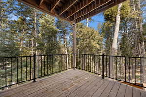 Deck featuring view of wooded area