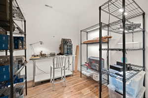 Home office with light wood-style flooring and baseboards