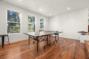 Game room featuring light wood-type flooring and recessed lighting