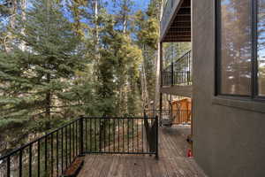Wooden terrace with view of wooded area