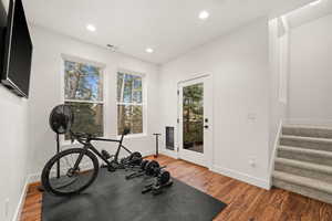 Exercise room featuring wood finished floors and recessed lighting