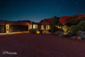 Southwest-style home featuring stucco siding, driveway, and an attached garage