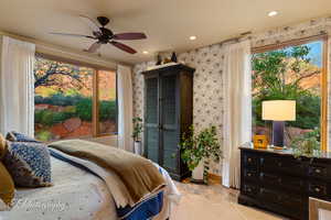 Bedroom with recessed lighting, wallpapered walls, a ceiling fan, and light tile patterned flooring