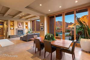 Dining area with built in features, a mountain view, beamed ceiling, recessed lighting, and french doors