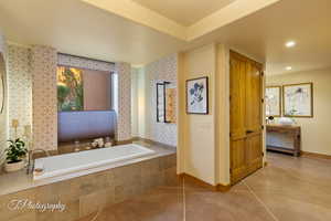 Bathroom with baseboards and a bath