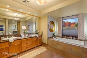 Bathroom featuring wallpapered walls, double vanity, a garden tub, recessed lighting, and a tray ceiling