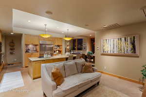 Living room with recessed lighting and light tile patterned floors