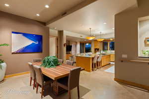Dining space featuring recessed lighting and light tile patterned floors