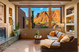 Living room featuring built in shelves, a fireplace, and a mountain view