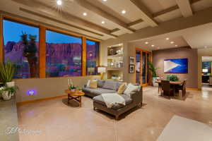 Living area featuring built in shelves, recessed lighting, and beamed ceiling