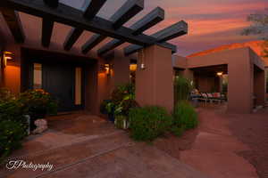 Entrance to property featuring stucco siding