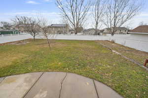 Fenced backyard with a residential view