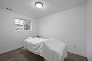 Carpeted bedroom with a textured ceiling
