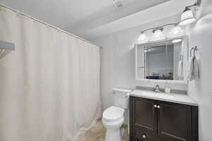 Full bathroom with vanity, a shower with shower curtain, and light tile patterned floors