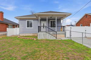 View of front of property with a gate, a porch, and a shingled roof