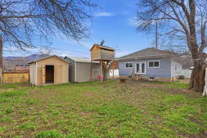 Rear view of house with french doors and a shed
