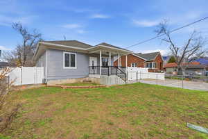 Bungalow-style house with a gate, a fenced backyard, a porch, and roof with shingles