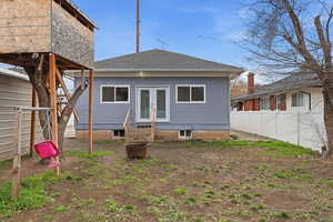 Back of property with french doors, entry steps, and roof with shingles