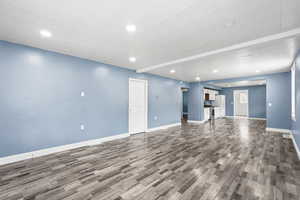 Unfurnished living room featuring recessed lighting.
