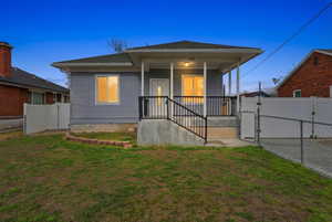 View of front of house featuring a gate and covered porch