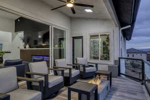 Wooden terrace featuring an outdoor living space with a fire pit and ceiling fan