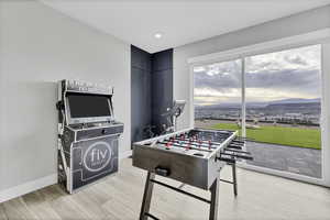 Rec room with light wood finished floors and recessed lighting