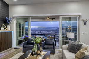 Living area featuring a mountain view, wood finished floors, and ceiling fan