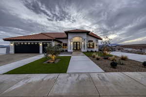 Mediterranean / spanish house featuring a tile roof, french doors, stucco siding, driveway, and a mountain view