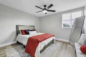 Bedroom with light wood finished floors and ceiling fan
