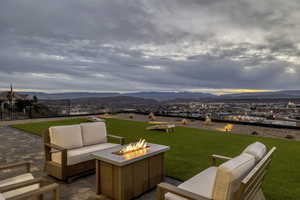 View of patio / terrace with an outdoor living space with a fire pit and a mountain view