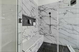 Bathroom with a marble finish shower