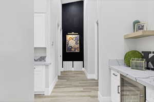 Corridor with beverage cooler and wood tiled floors