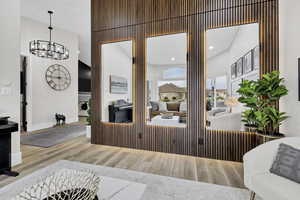 Living room featuring wood finished floors and suspended lighting
