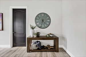 Interior space featuring wood tiled floors and baseboards