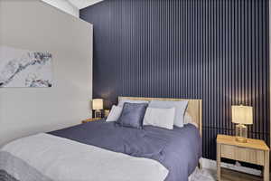 Carpeted bedroom with an accent wall