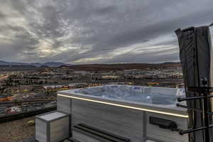View of patio / terrace with a mountain view and a hot tub