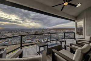 Balcony with an outdoor living space with a fire pit, a mountain view, and ceiling fan