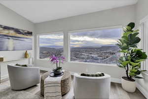 Living area featuring a mountain view, wood finished floors, and lofted ceiling