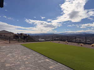 Fenced backyard featuring a mountain view