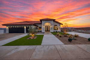 Mediterranean / spanish-style house featuring french doors, stucco siding, driveway, a tile roof, and a garage