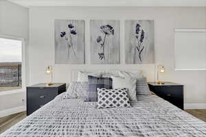Bedroom with light wood-type flooring and baseboards