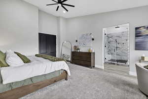 Carpeted bedroom with ensuite bathroom, ceiling fan, and a high ceiling