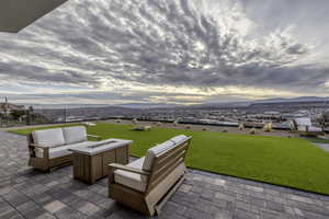 View of patio / terrace featuring a mountain view and an outdoor living space with a fire pit